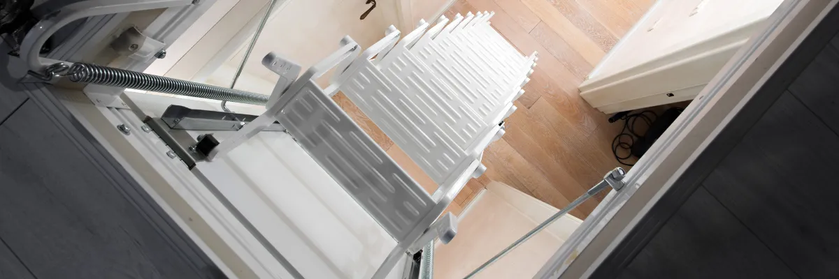 Unfolded foldaway stairs, leading up to a loft.
