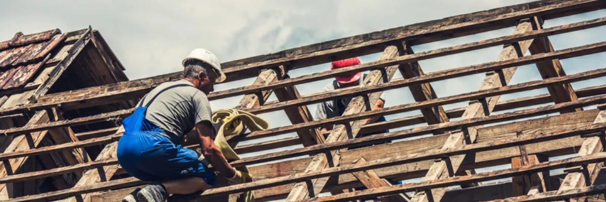 A roofing contractor working on a replacement roof.