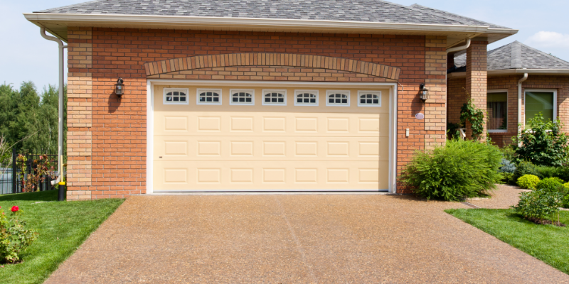 Resin Driveway Article Image A resin driveway in front of a house's garage.
