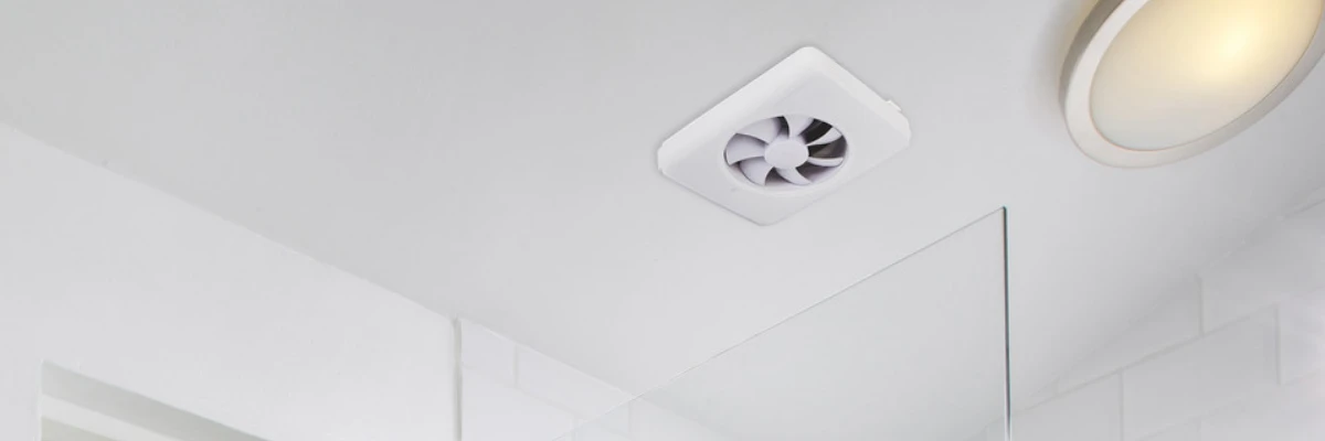 A white bathroom extractor fan installed on a ceiling.