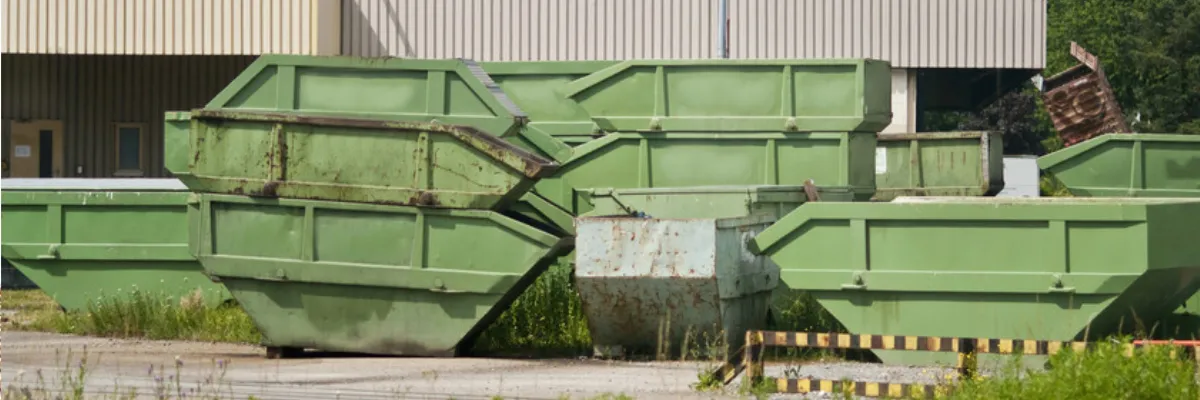 Several green skips stacked on top of each other.