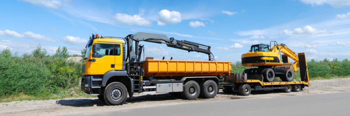 A grab lorry on the side of the road.