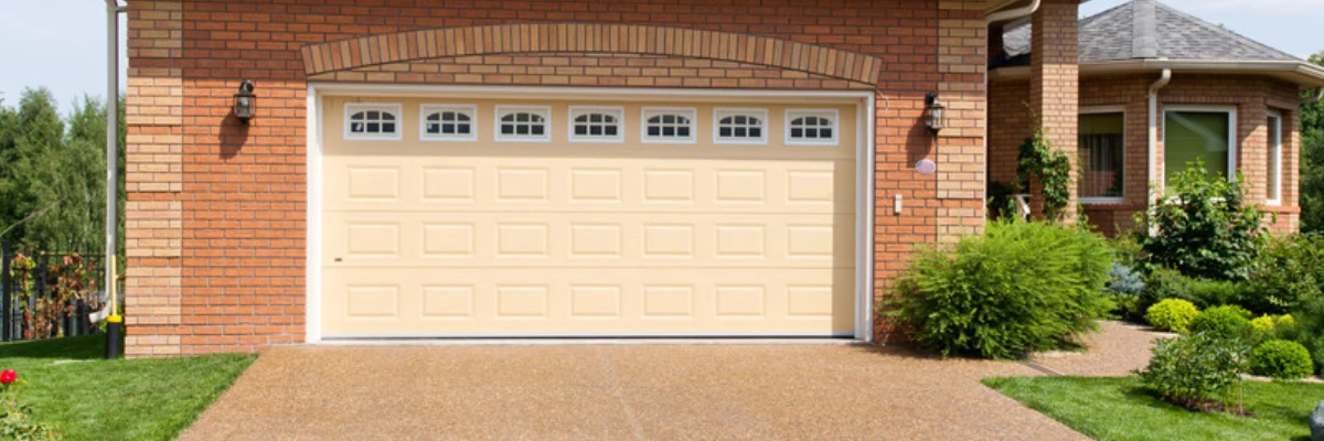 A resin driveway leading up to a garage.
