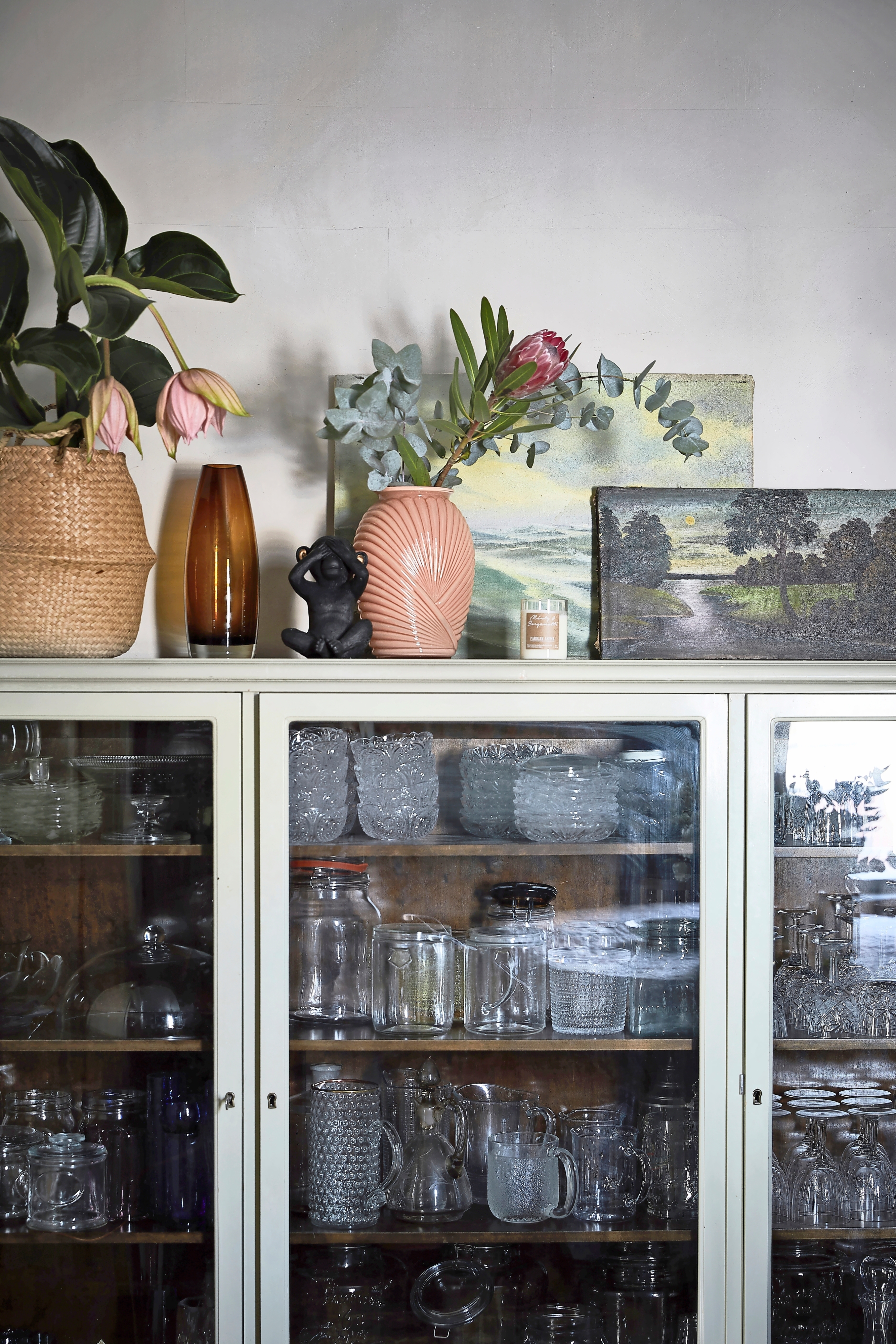 An antique sideboard showcasing an extensive collection of vintage glassware