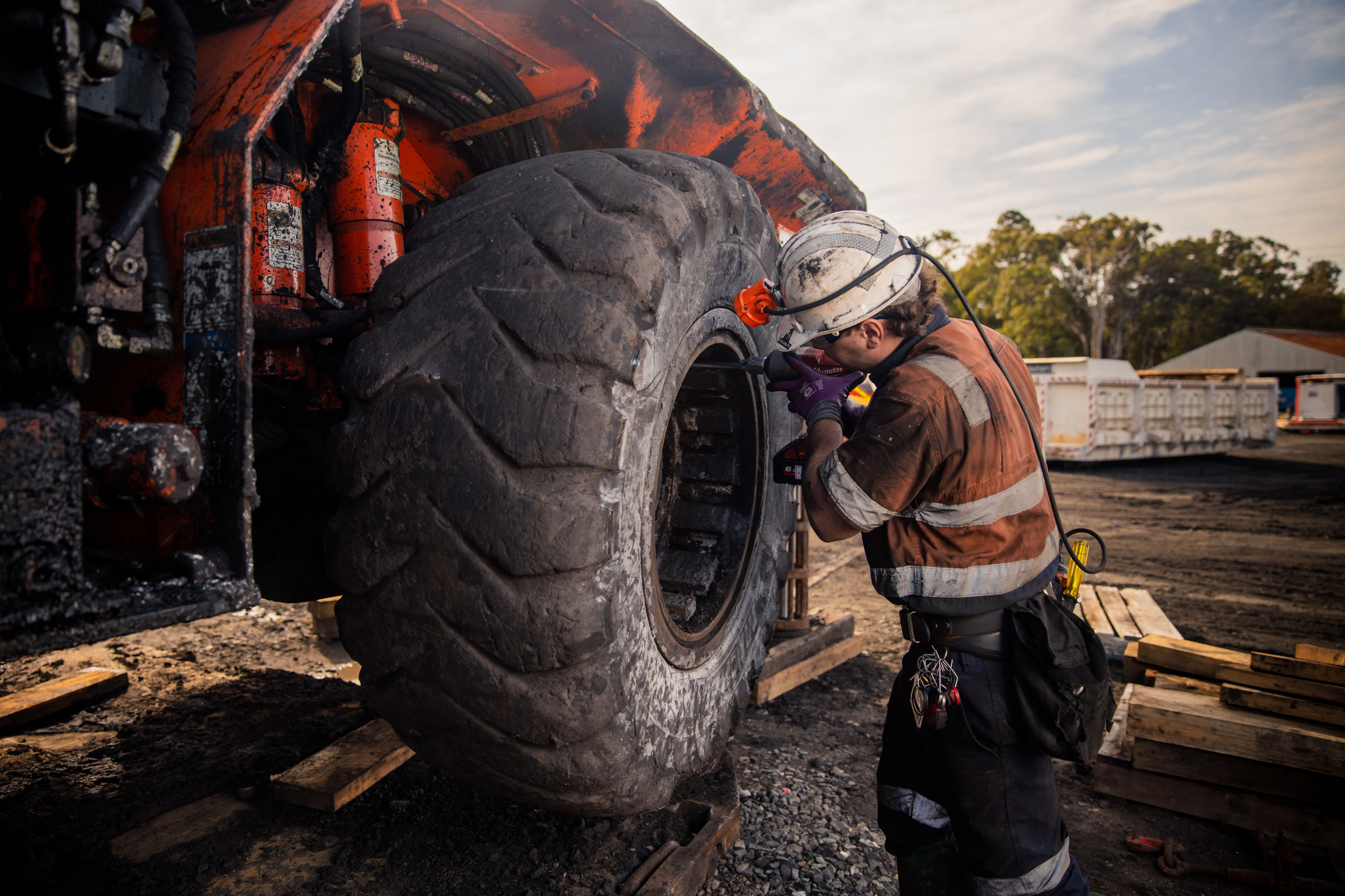 Mine workers discussing tasks next to a truck