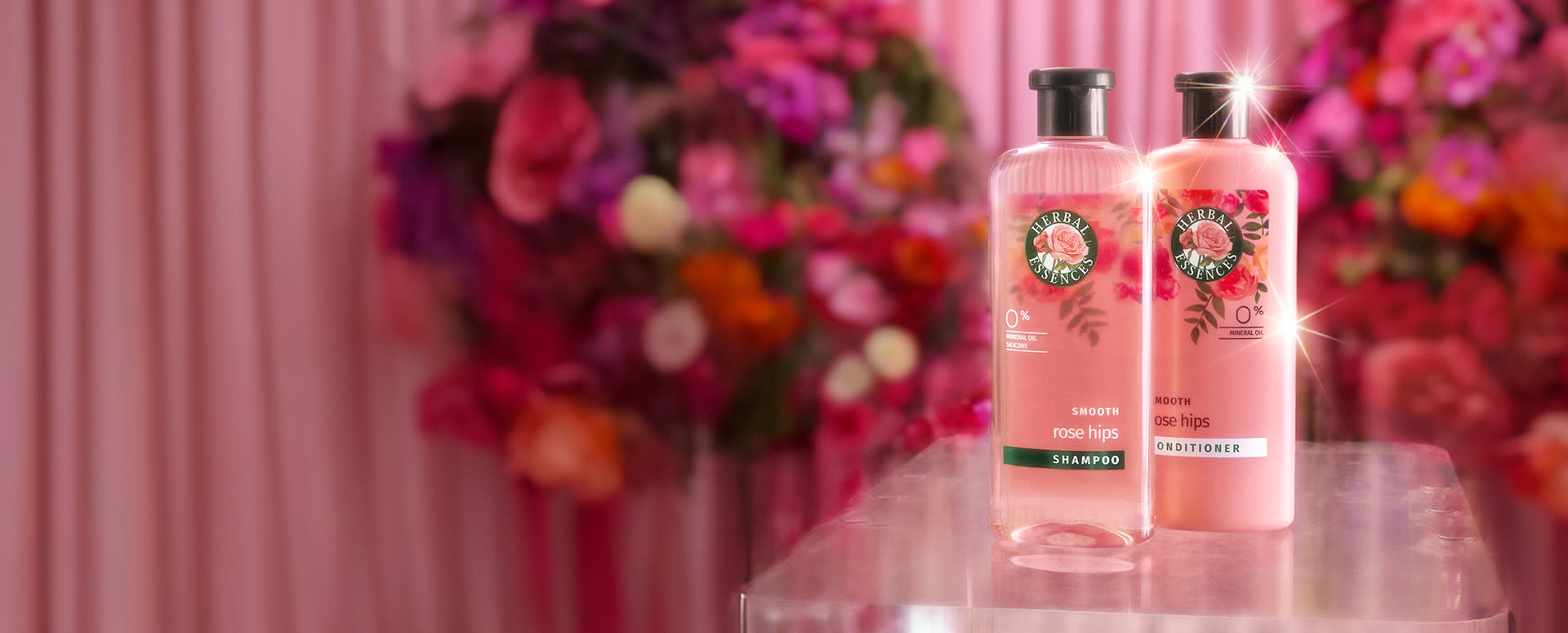 Herbal Essences Smooth Rose Hips product on a pink floral background