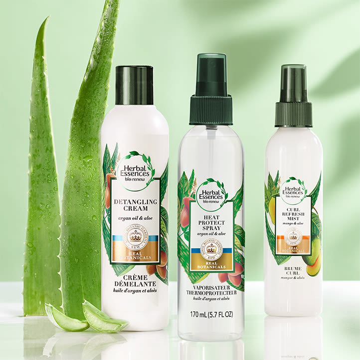 Argan oil and aloe heat protect spray, tetangling cream and curl refresh mist products placed next to each other