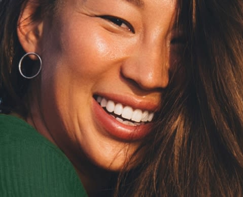 African-American woman with curly hair smiling