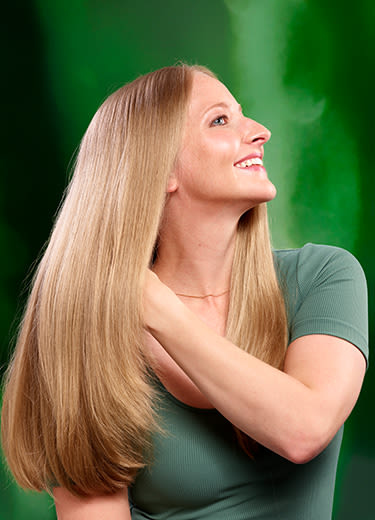 Blonde woman smalling on a blurry nature background