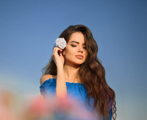 caucasian woman with brown hair smiling at the camera