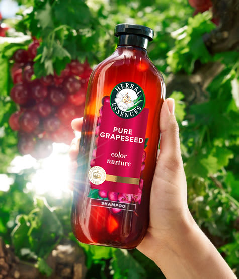 Woman hands applying Herbal Essences Cream on palm