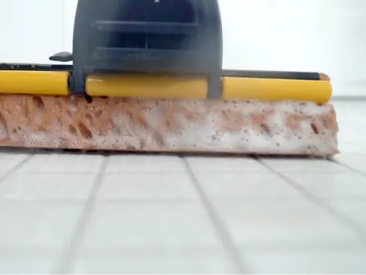 Close up of mop head cleaning a tile floor