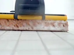 Close up of mop head cleaning a tile floor