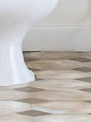 neutral & brown linoleum next to porcelain toilet