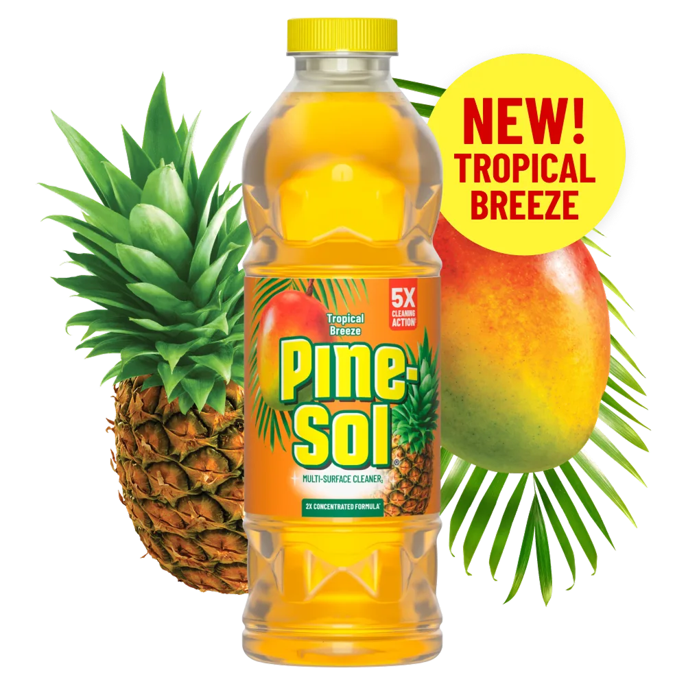 Bottle of Tropical Breeze cleaner with mango and pineapple in the background