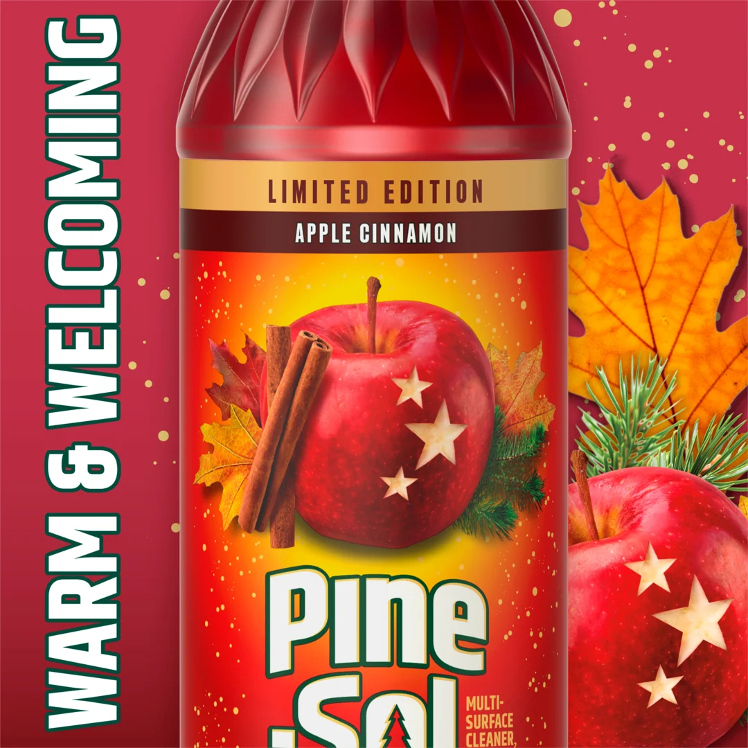 Limited Edition Apple Cinnamon Pine-Sol bottle with red apple, cinnamon sticks, and autumn leaves on festive red background.