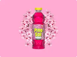 Bottle of Pine-Sol Cherry Blossom cleaner with cherry blossoms in background, on pink gradient.