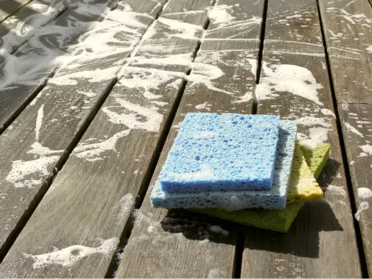 Sudsy wooden deck with varicolored sponges