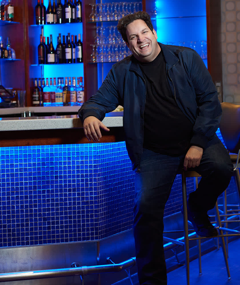 David Harris Leaning against bar in comedy club