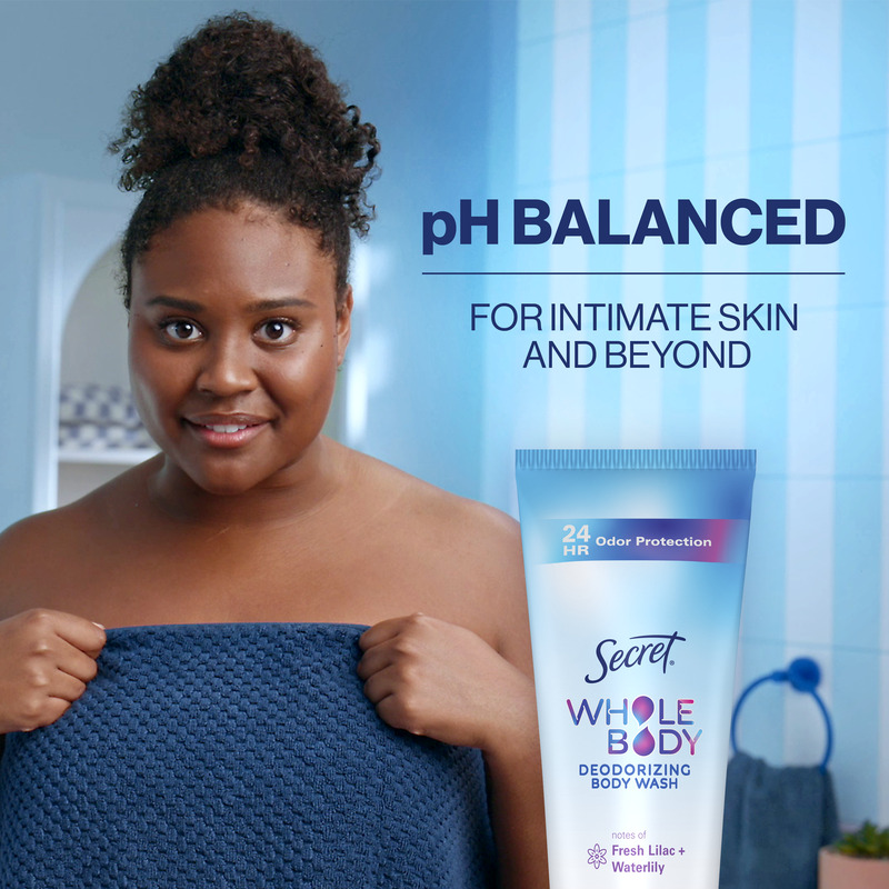 Woman holding a towel, showcasing pH balanced Secret Whole Body Deodorizing Body Wash for intimate skin care