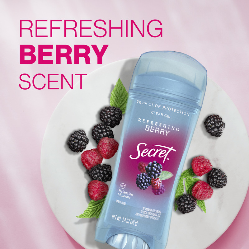 Refreshing berry scent. Secret clear gel deodorant, surrounded by fresh raspberries and blackberries on a plate, set against a pink background