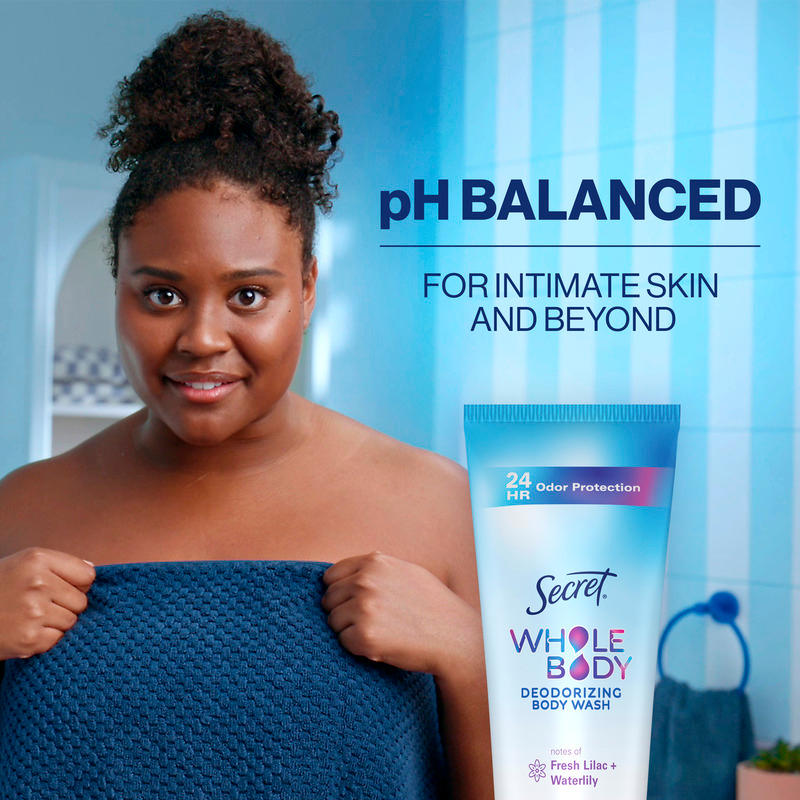Woman holding a towel, showcasing pH balanced Secret Whole Body Deodorizing Body Wash for intimate skin care