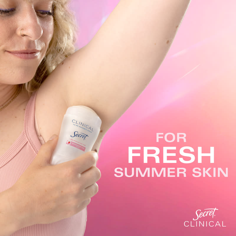Woman applying Secret Clinical deodorant for fresh summer skin, showcasing confidence and skincare routine