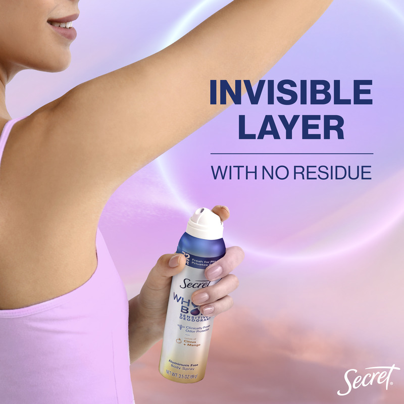 Woman applying Secret deodorant spray in a gentle motion under her arm, promoting an invisible layer with no residue left behind