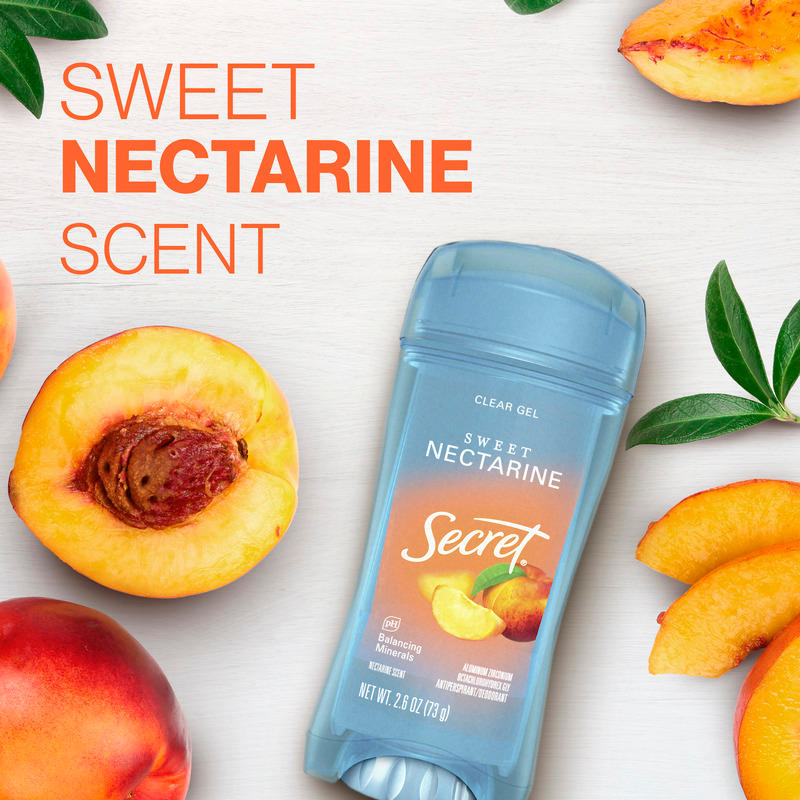 Secret clear gel deodorant featuring sweet nectarine scent, surrounded by fresh nectarines and leaves on a wooden background
