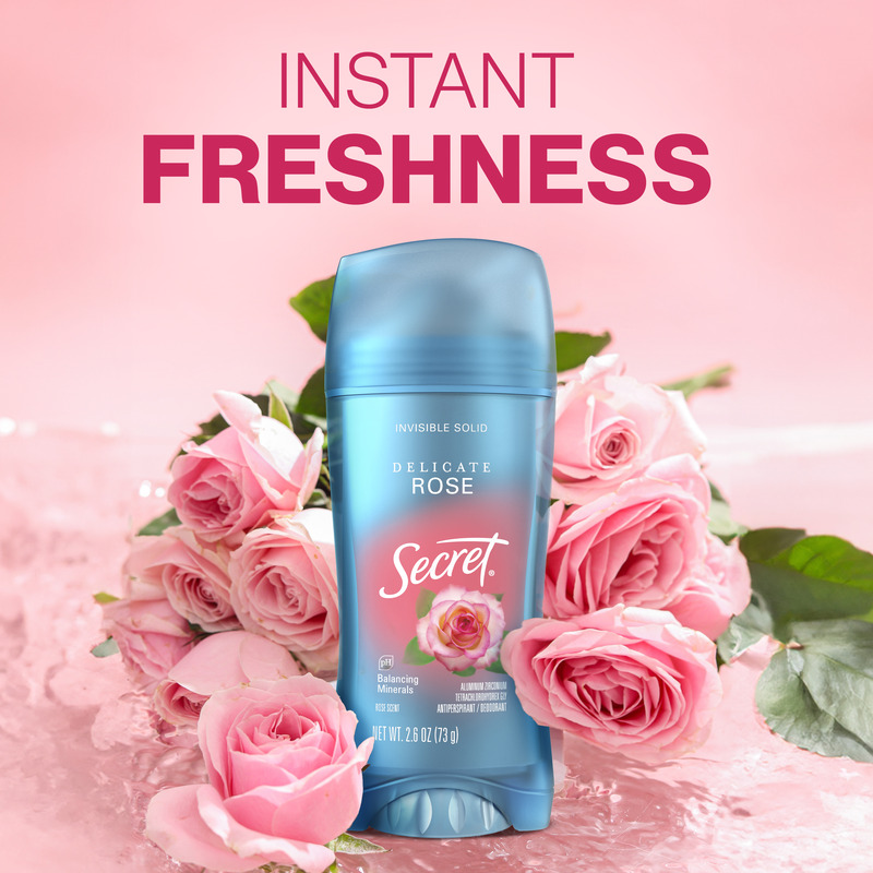 Secret deodorant stick in Delicate Rose scent surrounded by pink roses, emphasizing instant freshness and floral fragrance