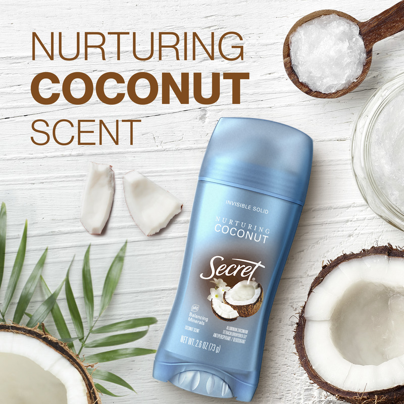 Instant freshness. Secret deodorant with nurturing coconut scent next to whole and sliced coconuts