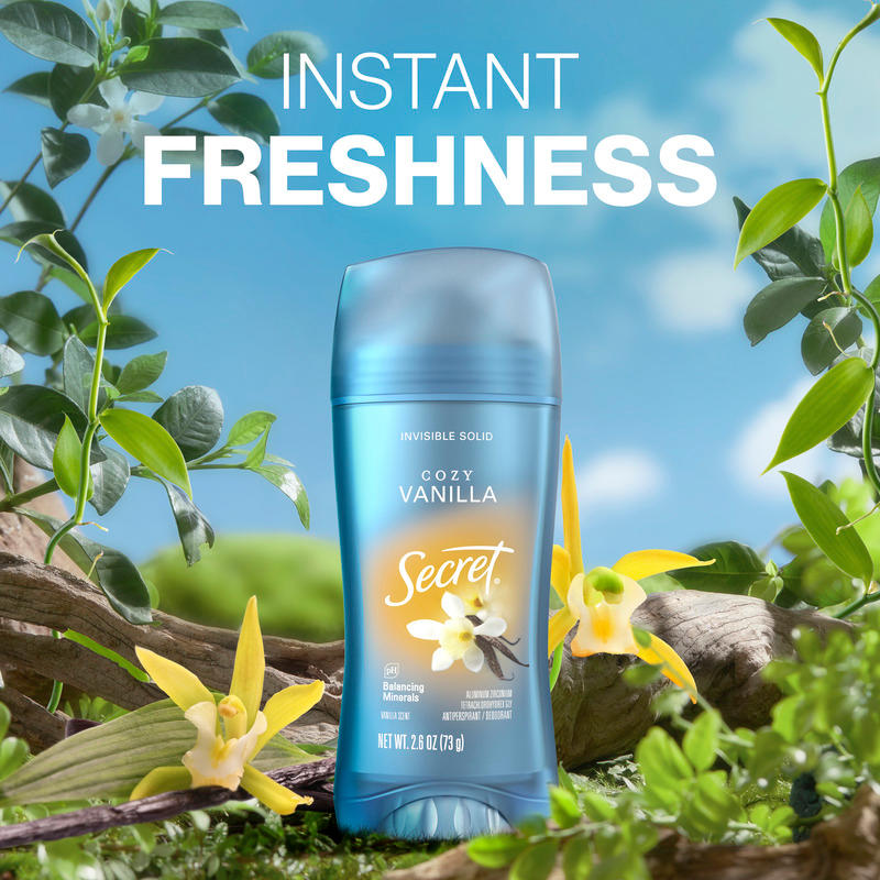 Secret deodorant stick, Cozy Vanilla surrounded by yellow flowers and green leaves, conveying a sense of freshness and natural appeal