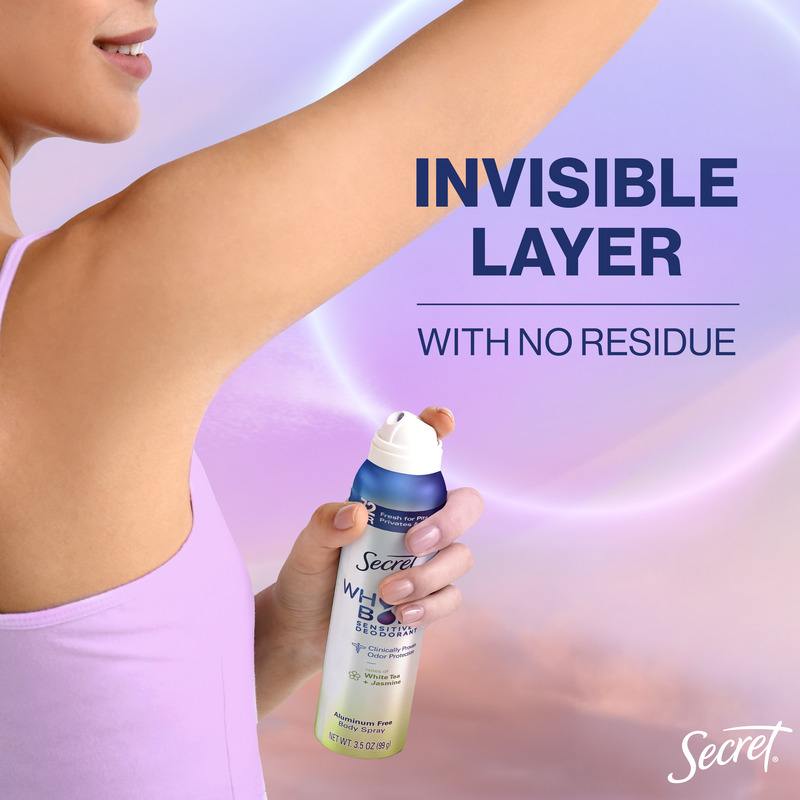 Woman applying Secret deodorant spray in a gentle motion under her arm, promoting an invisible layer with no residue left behind