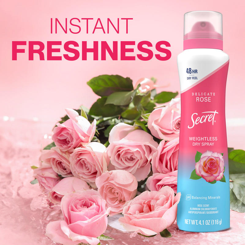 A bottle of Secret Weightless Dry Spray next to a bouquet of pink roses, promoting instant freshness and long-lasting fragrance for users