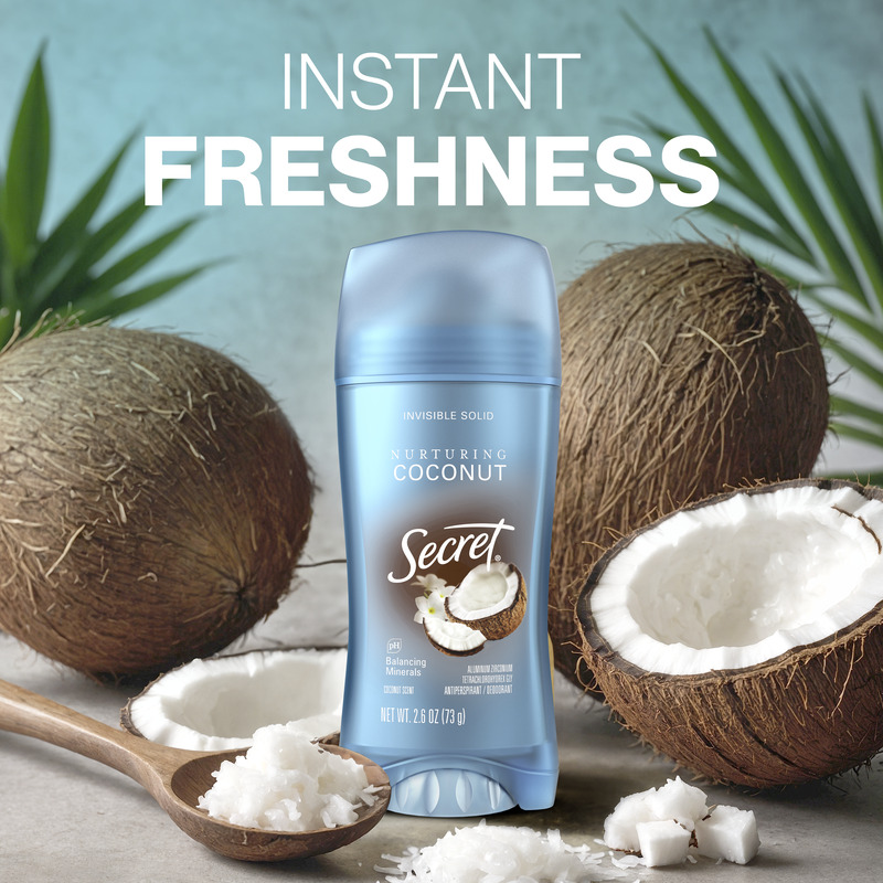 Instant freshness. Secret deodorant with nurturing coconut scent next to whole and sliced coconuts