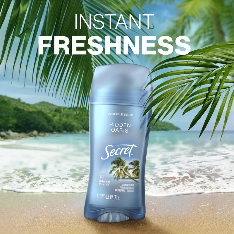 Secret deodorant stick, Hidden Oasis positioned on a sandy beach with palm leaves, emphasizing instant freshness and a tropical vibe