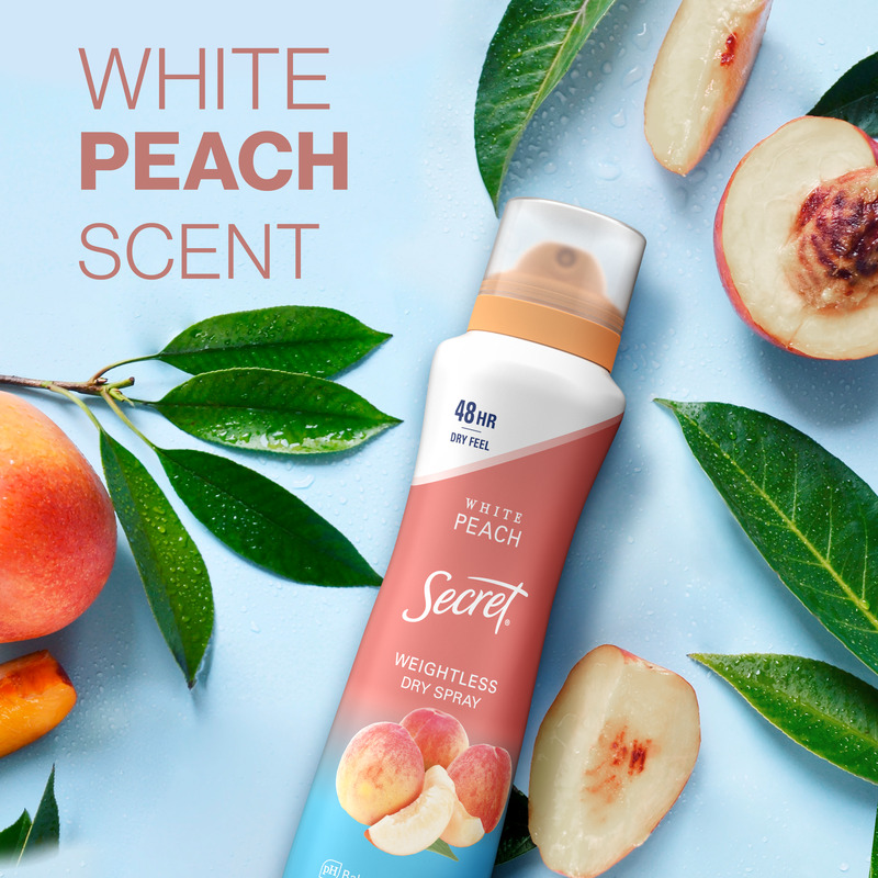 Weightless dry spray by Secret featuring white peach scent with fresh peaches and green leaves, highlighting the refreshing fragrance experience