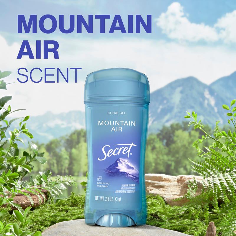 Mountain air scent. Secret clear gel deodorant with Mountain Air scent surrounded by natural greenery and a scenic mountain backdrop