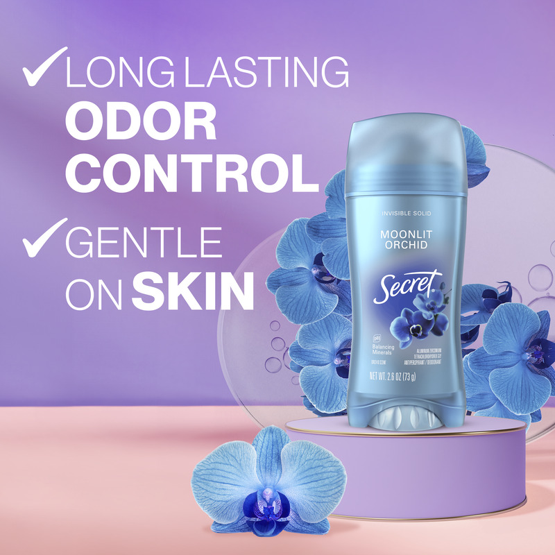 Secret deodorant stick with Moonlit Orchid scent surrounded by light blue orchids, highlighting long-lasting odor control and gentle on skin benefits