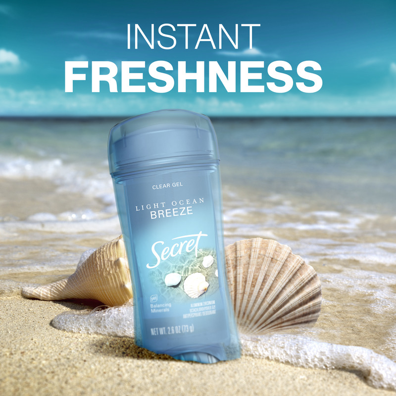 Secret clear gel deodorant in Light Ocean Breeze scent on a sandy beach with seashells, conveying a sense of instant freshness and relaxation