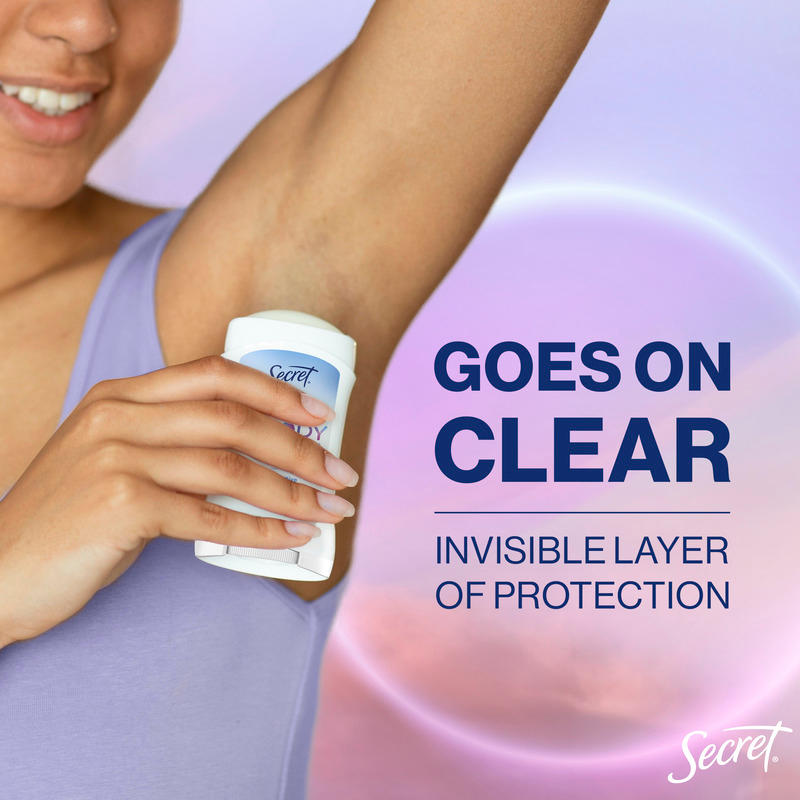 Woman applying Secret dry solid, showcasing the clear formula that provides an invisible layer of protection against odor