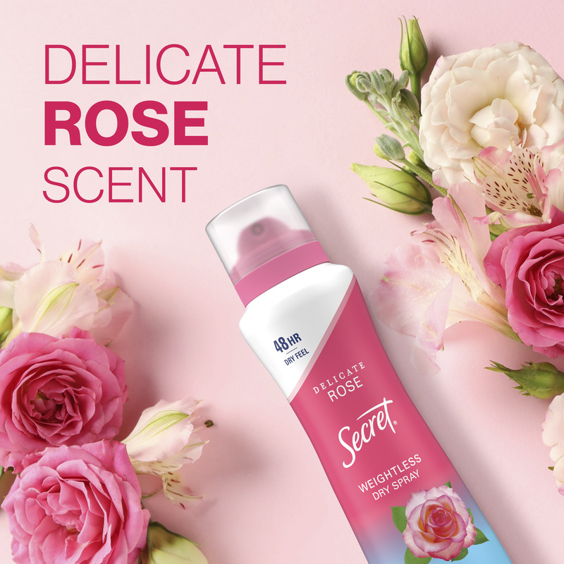 Weightless dry spray by Secret featuring delicate rose scent, surrounded by pink floral accents on a soft pastel background. Ideal for freshening up