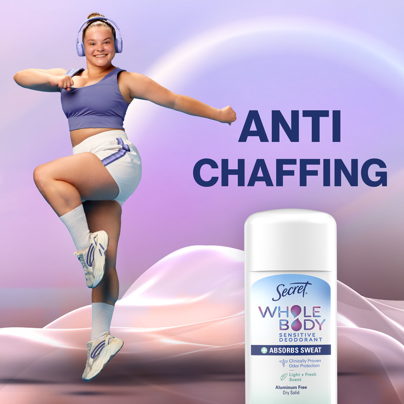 A joyful person wearing sportswear dances energetically next to a Secret dry solid stick, promoting a product that prevents chafing and absorbs sweat