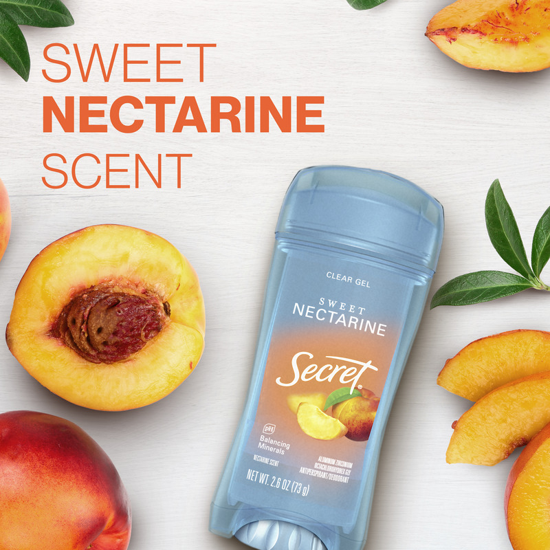 Secret clear gel deodorant featuring sweet nectarine scent, surrounded by fresh nectarines and leaves on a wooden background