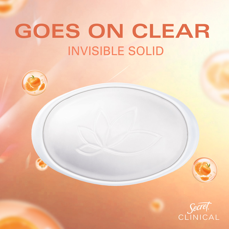 Clear invisible solid deodorant with lotus design on a soft, colorful background featuring mandarin elements