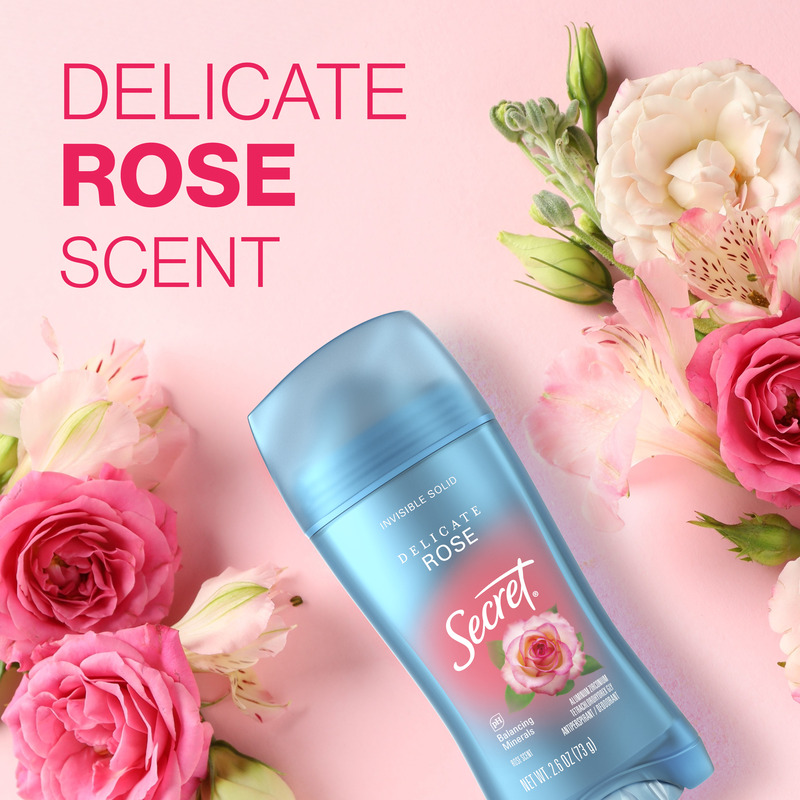 Secret deodorant stick with a delicate rose scent surrounded by pink and white flowers on a pink background, promoting freshness and floral aroma