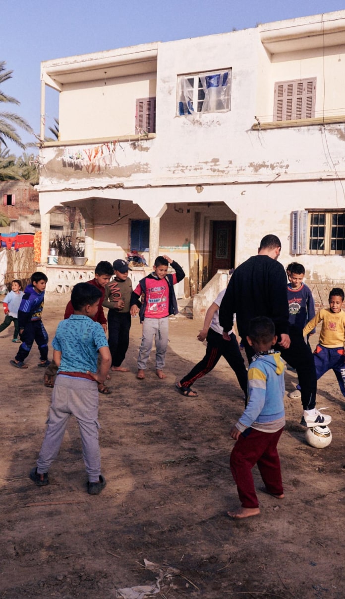 Kotn’s Senior Director of Supply Chain, playing soccer in one of the cotton farming villages.