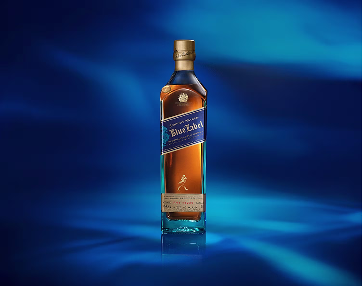 A bottle of Johnnie Walker Blue Label whisky stands on a blue, illuminated background.