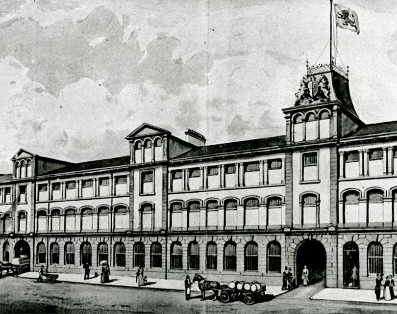 A historic illustration depicting a grand building with ornate details, likely a factory or warehouse from the industrial era.