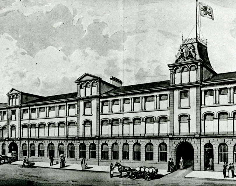 A historic illustration depicting a grand building with ornate details, likely a factory or warehouse from the industrial era.
